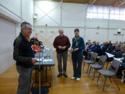 Rex Markby presents Carol and Len Richardson with their name badges